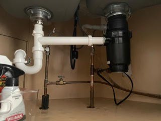 picture of newly installed pvc piping and garbage disposal installed for a customer 
